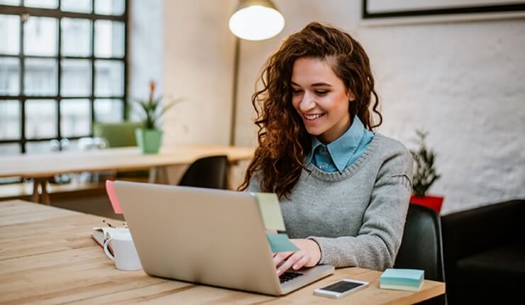 Woman smiling at laptop