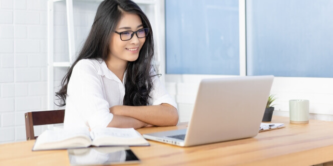 Woman smiling at laptop