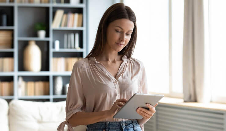 woman typing on tablet