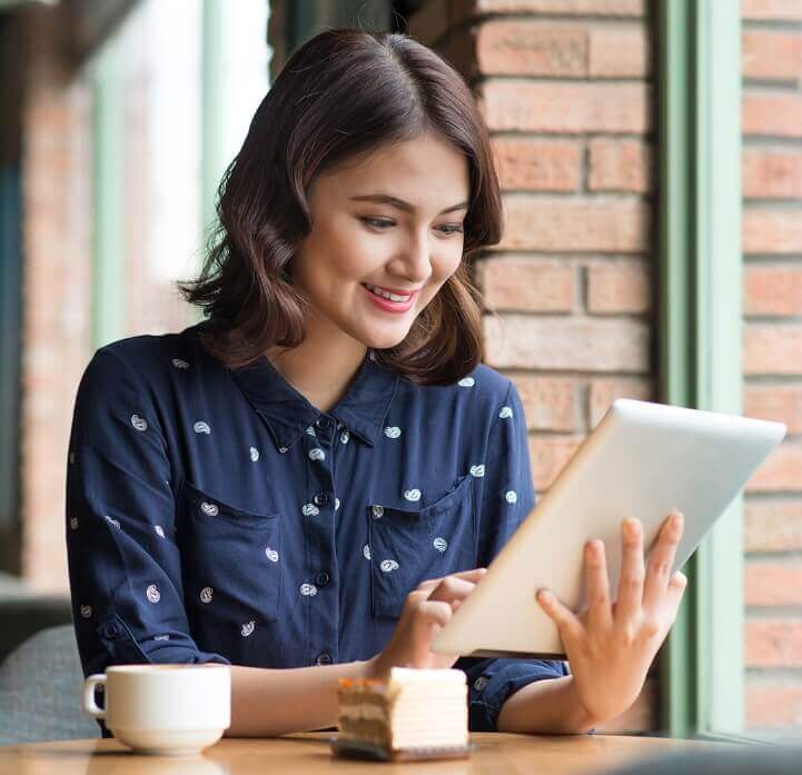 Woman smiling at tablet