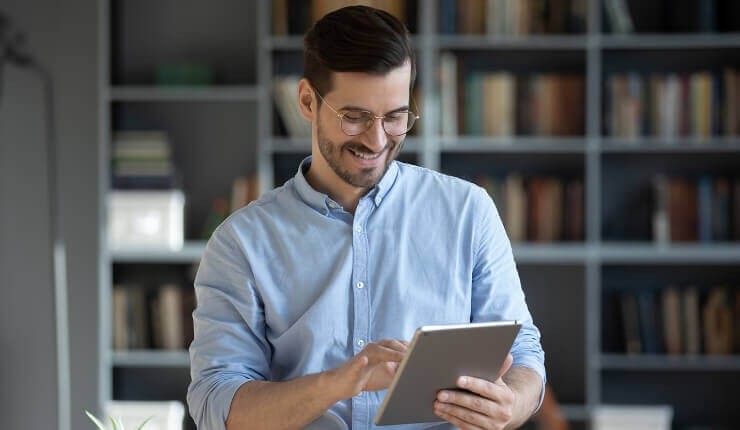 man smiling at tablet