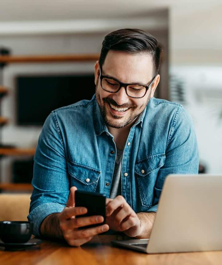 Man smiling at mobile phone