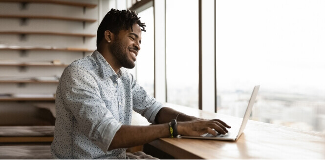 Man smiling at computer