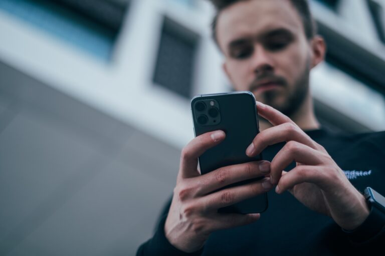 An image of a man, faxing multiple pages using a mobile device.